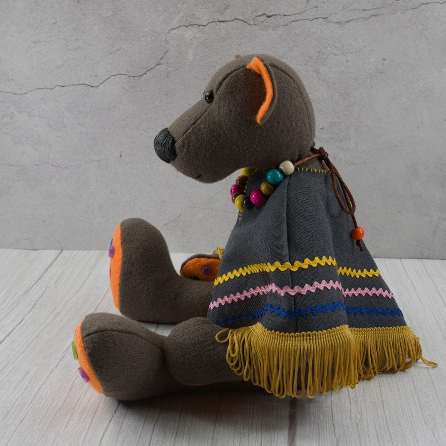 Handmade textile dark brown bear with a poncho and a wooden bead necklace