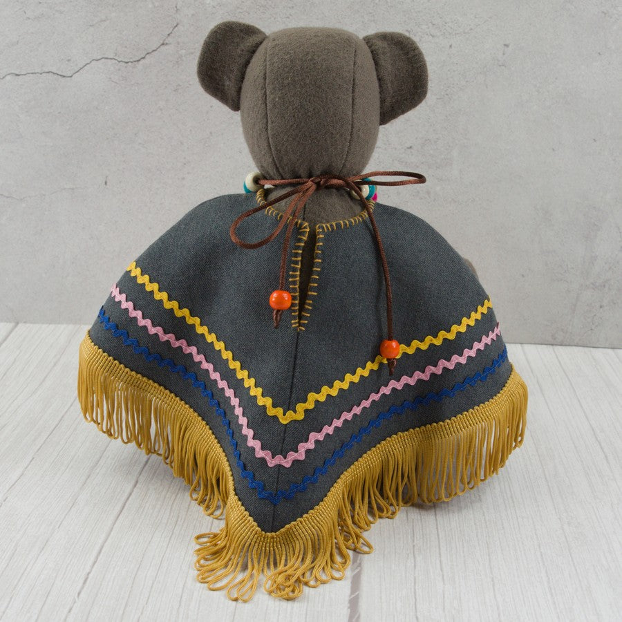 Handmade textile dark brown bear with a poncho and a wooden bead necklace